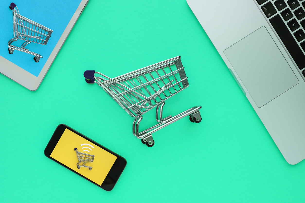 shopping cart with laptop, smartphone, and tablet | ecommerce trends 2022